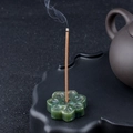 Green crystal lotus incense holder with petal carving and burning stick detail - India Agate