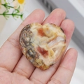 Polished natural agate worry stone in heart shape with red and yellow swirls - Crazy Agate