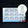 Set of 12 opalite gemstone cat figurines in a blue display box with a macro view - Opal (Synthetic)