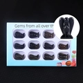 Set of 12 black obsidian angel figurines in a blue gift box with a detail inset view - Obsidian