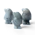 Three hand-carved labradorite penguin figurines with natural stone texture and polish - Labradorite