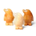 Three hand-carved natural yellow crystal penguin figurines with smooth polished finish - Topaz