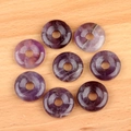 Set of eight purple amethyst crystal donut beads for DIY jewelry making on wood background - Purple Crystal