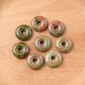 Set of eight Unakite natural stone donut beads with green and pink mottled patterns - Unakite