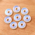 Polished opalite donut beads showing translucent milky white glow for DIY jewelry making - Synthetic Opal