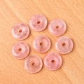 Flat lay of eight rose quartz donut pendants on a light wood background for DIY jewelry - Rose Quartz (1pc)