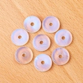 Set of 8 translucent light blue opalite donut pendants on a wooden background - Opalite (Synthetic)