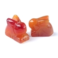 Polished natural carnelian rabbit figurines in vibrant orange and yellow tones - Red Agate