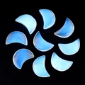 Nine crescent moon-shaped opalite stones in a circle on a black background - Opal (Synthetic)