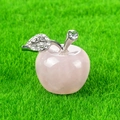 Pink rose quartz apple figurine with silver leaf detail on green grass background - Rose Quartz