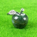 Green moss agate crystal apple ornament with silver rhinestone leaf on grass background - India Agate