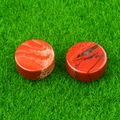 Set of two polished round red jasper natural stones on green background - Red Jasper