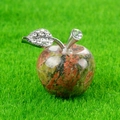 Apple-shaped Unakite gemstone ornament with silver rhinestone leaf on green lawn - Unakite