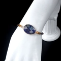 Faceted blue natural stone bracelet with gold plating and brown braided adjustable cord - Blue Sodalite