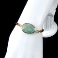 Adjustable woven rope bracelet with faceted green gemstone and golden metal bezel - Amazonite