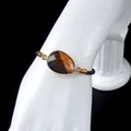 Adjustable woven rope bracelet with gold-edged oval tiger's eye stone charm - Tiger's Eye