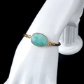 Adjustable brown braided cord bracelet featuring a faceted oval turquoise gemstone with gold trim - Amazonite
