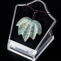 Natural light green jade maple leaf pendant with a dark red cord in a crystal display box - India Agate