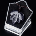 Blue goldstone maple leaf pendant with glittering star effect on a brown braided cord - Blue Sandstone