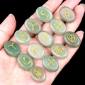 Green aventurine rune stones with golden celestial symbols held in person's hand - 13 Pieces/Pack / Green Aventurine (1712)