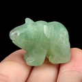 Translucent green aventurine polar bear figurine held between fingers for size - Green Aventurine