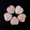 Set of five heart-shaped pink rose quartz stones with golden Wealth engraving - Wealth