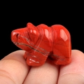 Miniature Red Jasper hippo carving with natural dark veins held between fingers - Red Jasper