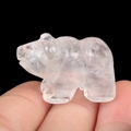 Handcrafted polar bear carving in translucent white crystal stone held by hand - White Crystal
