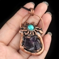 Vintage bronze sun pendant with purple crystal ore and turquoise inlay on black rope - Amethyst