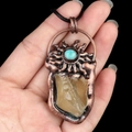 Handheld vintage copper necklace featuring a raw yellow crystal and turquoise inlay - Citrine