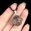 Spherical natural gray agate planet pendant with red spots and black woven cord - Planet Shape (1926) / African Blood Stone