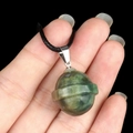 Green natural agate stone planet pendant with rings on a black braided cord necklace - Planet Shape (1926) / India Agate