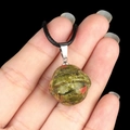 Unakite planet pendant with green and pink stone texture on a black cord necklace - Planet Shape (1926) / Unakite
