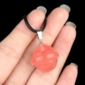 Pink lollipop pendant crafted from translucent resin on a black woven cord necklace - Planet Shape (1926) / Watermelon Red (Synthetic)
