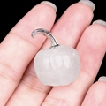 Mini white crystal pumpkin figurine with silver stem held by hand for scale - White Crystal