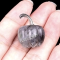 Miniature gray purple gemstone pumpkin carving with silver stem held in palm - Labradorite