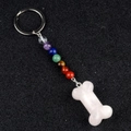 Chakra stone keychain featuring 7 colorful beads and a white bone pendant carving - Rose Quartz