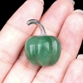 Mini pumpkin stone carving in green aventurine held in hand for size visualization - Green Aventurine