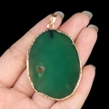Large irregular green agate slice pendant with gold plated edge held in hand - Green Agate (Gold Edge)