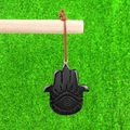 Polished black Hamsa hand pendant with evil eye engraving and brown leather cord - Obsidian