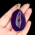 Large purple druzy agate slice pendant with gold plated edges shown in hand - Purple Agate (Gold Edge)
