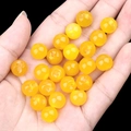 Translucent yellow agate round beads held in hand for handmade jewelry crafts - Yellow Agate (2040)