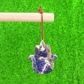 Handcrafted Hamsa Hand natural stone pendant with blue mineral patterns on faux grass - Blue Sodalite