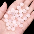 Pink translucent round beads of natural agate for DIY jewelry shown in hand on black background - White Agate (2040)