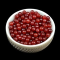 Polished 4mm red carnelian natural stone round beads displayed in a ceramic bowl - Red Agate (Single Bead) 4mm No Hole