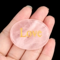 Polished heart-shaped rose quartz palm stone with elegant gold Love engraving - LOVE (Rose Quartz)