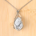 Silver mesh cage necklace with teardrop white marble stone pendant on bamboo background - White Turquoise Egg