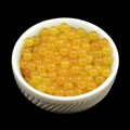 Polished 4mm translucent yellow natural stone beads displayed in a white textured ceramic bowl - Yellow Agate (Single Bead) 4mm No Hole