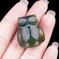 Miniature owl owl figurine carved from natural green and brown agate stone shown in hand - India Agate