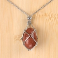 Silver chain necklace with reddish brown goldstone egg in a metal mesh cage - Goldstone (Synthetic) Egg